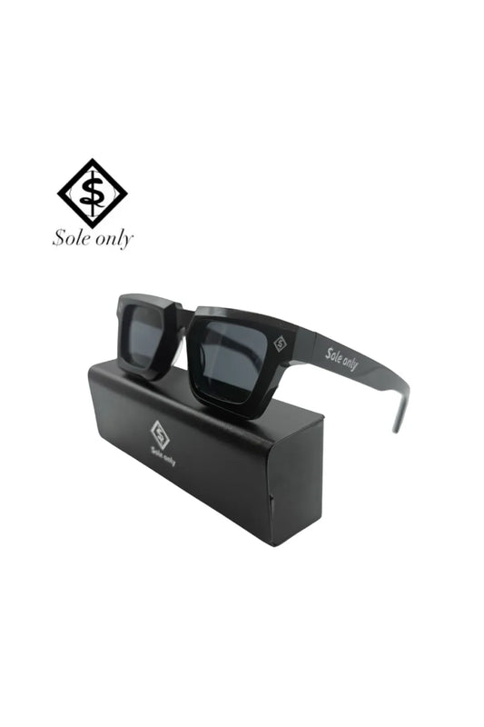 $ole only Monarch Square Sunglassesの斜めショット。フロントサイドにあしらわれた菱形のロゴパーツと、光のぎらつきを抑える黒の偏光レンズ。