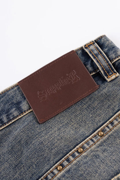 【SUPPLIER】 Studs Tribal Leather Patch Curve Denim （BLUE）ブランド型押しレザーパッチディテール